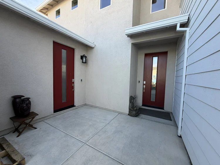 The entry courtyard, with the front door and a second red door.