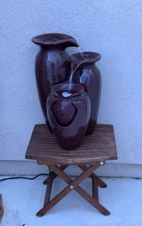 A ceramic water fountain on the patio.