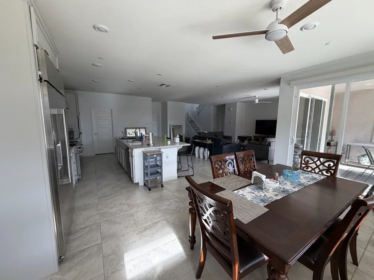 The dining table and the kitchen, seen from the dining area.