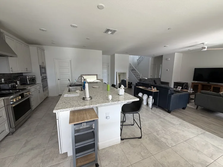The kitchen, with the living area and the staircase beyond.