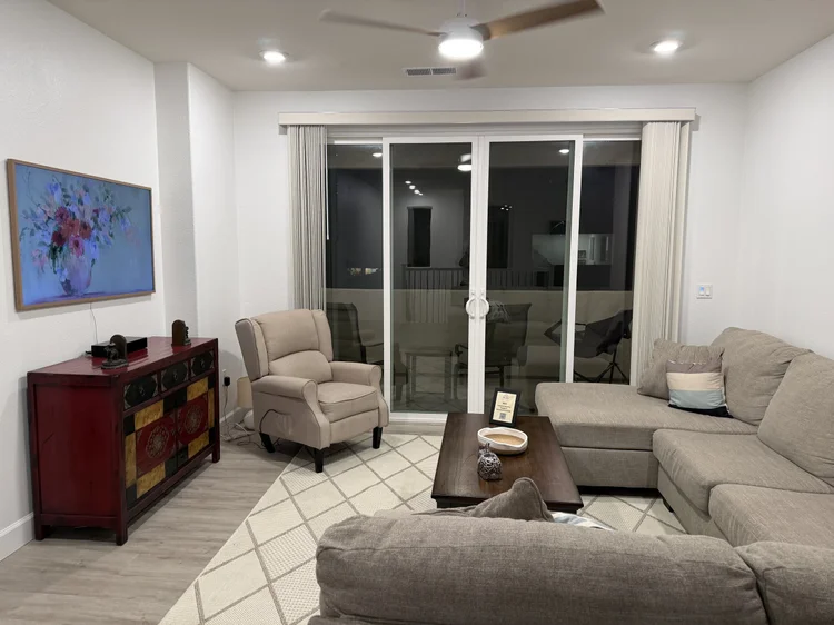 The living area with a sectional sofa and a recliner.