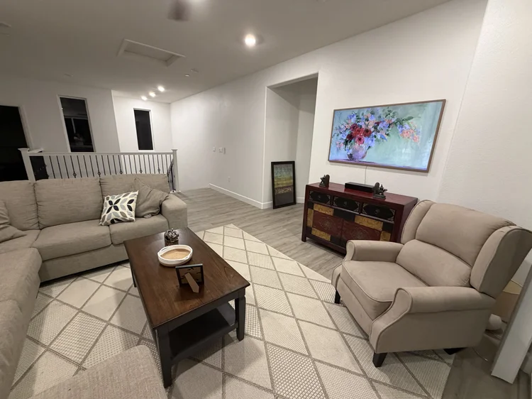 The upstairs loft, furnished with sofas and a console.