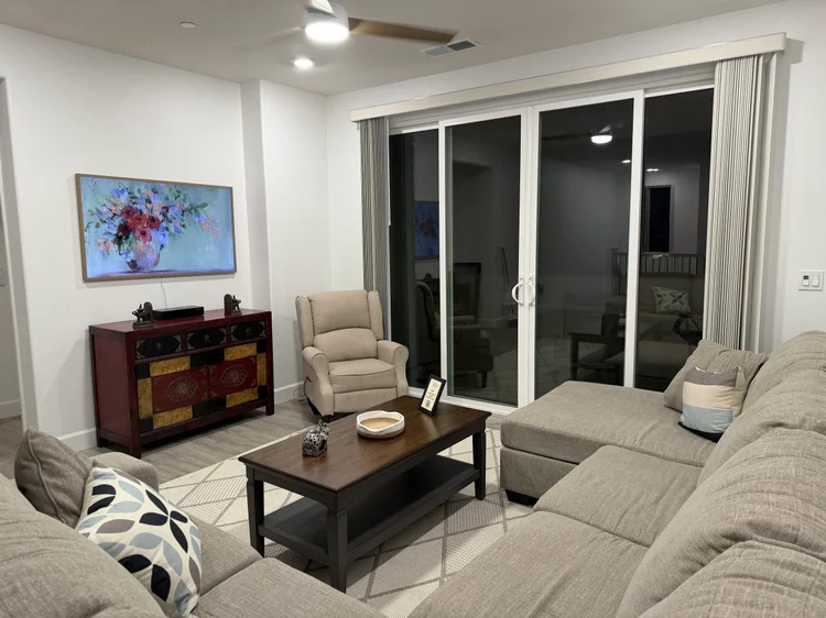 The living area in the evening, with sliding doors to the patio.