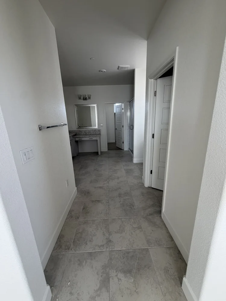The hallway leading to an upstairs bathroom.
