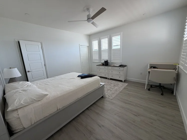 A furnished private bedroom with shuttered windows.