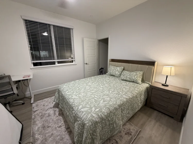 The Private Bedroom with Shared Bathroom, with a desk by the window.