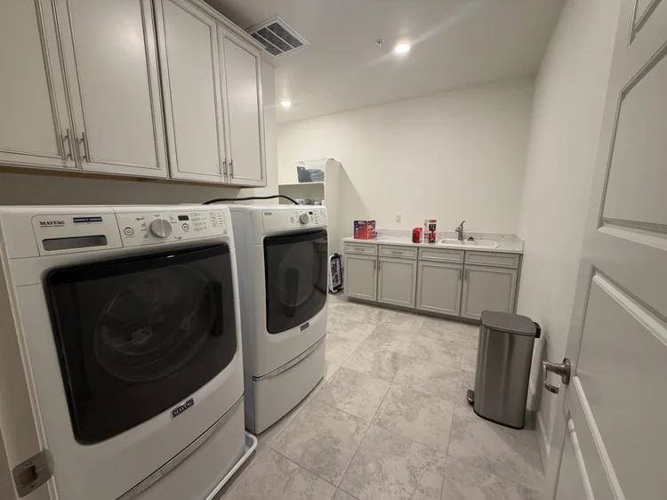 The upstairs laundry room, with a washer and dryer.