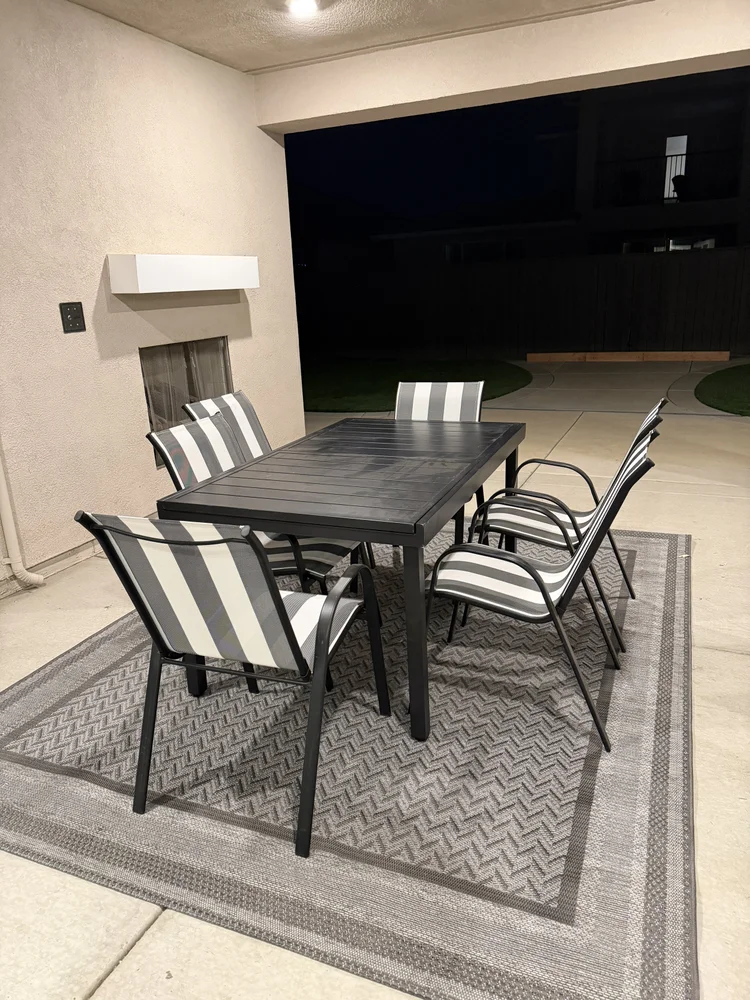 The covered patio in the evening, set for outdoor dining.