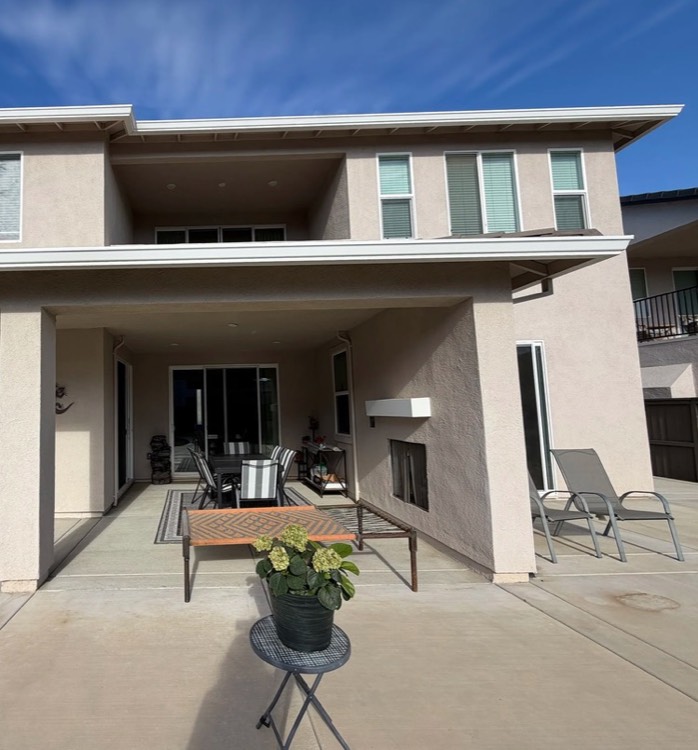 The back of the home, with the covered patio below and the shared balcony above.