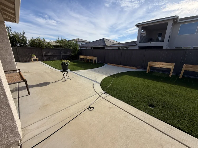 The backyard lawn and raised garden beds.
