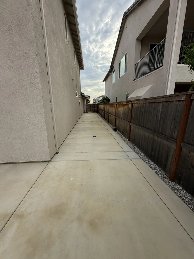The walkway along the side of the house.